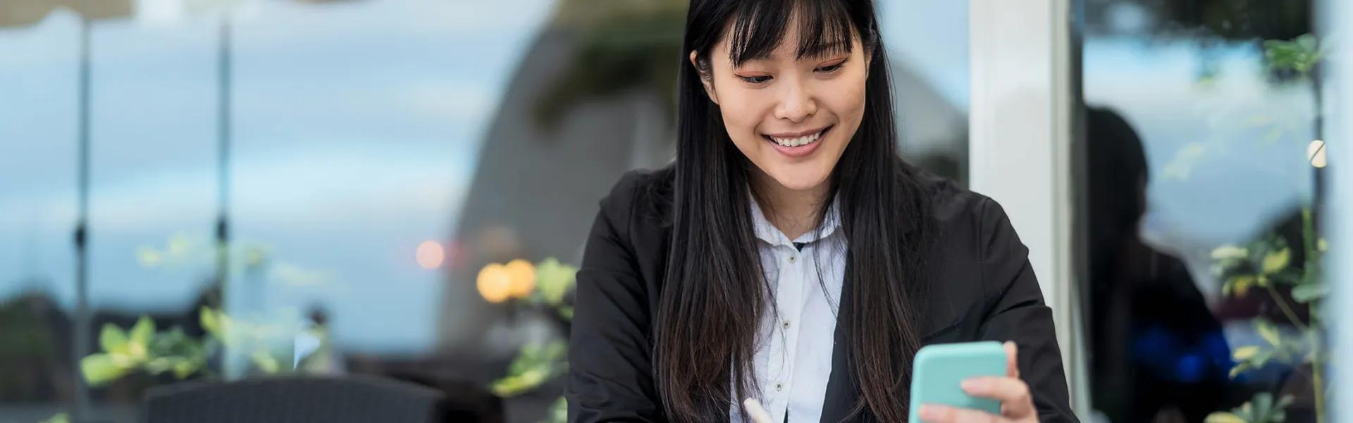 young woman outside using phone