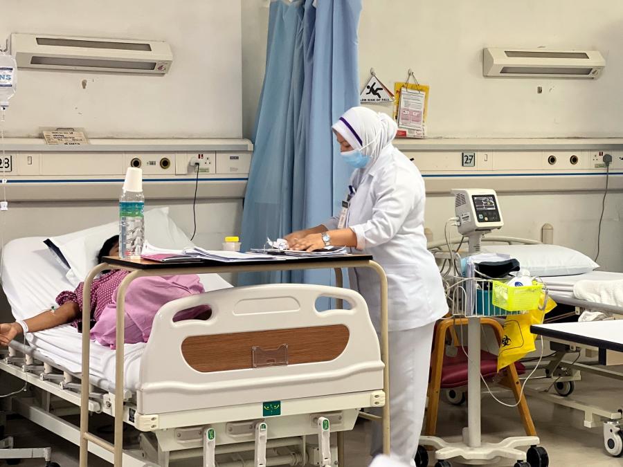 A staff nurse checks on a patient at the postnatal ward in Selayang Hospital, Selangor. The postnatal ward has a rapid turnover rate as most patients who go through vaginal delivery can be discharged within 24 hours after delivery or would stay at least one night before going home. Meanwhile, the average hospital stay after a C-section is two to four days. Photo by Saw Siow Feng, taken on July 16, 2023.