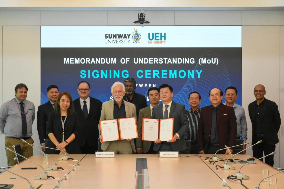 Esteemed guests pose with the signed document