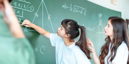Students doing mathematics on blackboard